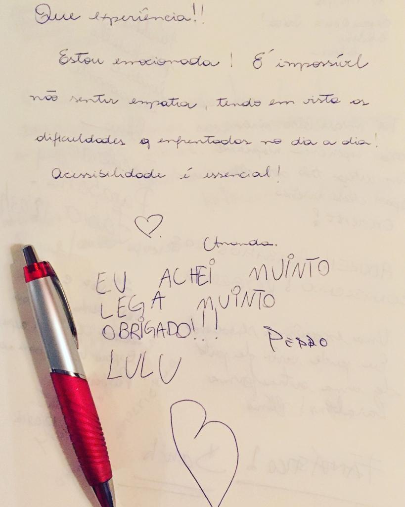 Livro de comentários da Exposição: (1) "Que experiência!! Estou emocionada! É impossível não sentir empatia, tendo em vista as dificuldades enfrentadas no dia a dia! Acessibilidade é essencial! Amanda (com desenho de coração)" (2) Eu achei 'muinto' lega 'muinto' obrigado!!! Lulu Pedro (com desenho de coração) e letra de crianças.